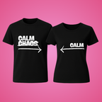 Two black t-shirts with white text on a pink background