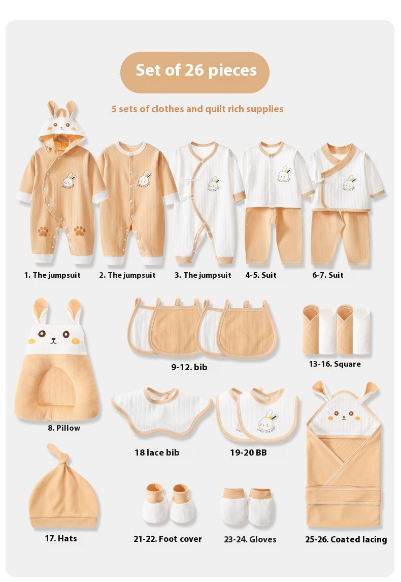 Set of 26 baby clothing and quilt items with labels on a white background