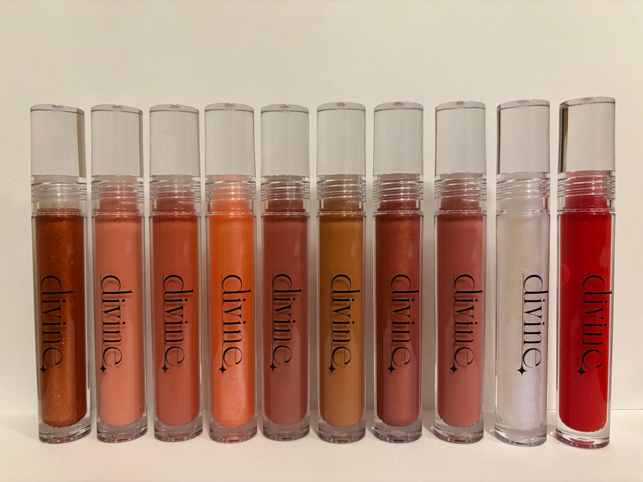 Row of 'divine' lip glosses in various colors on a light background