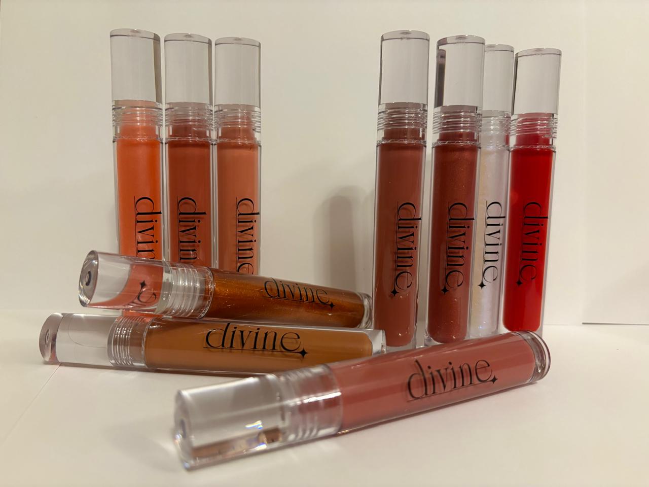 Set of divine lip glosses in various shades on a white background